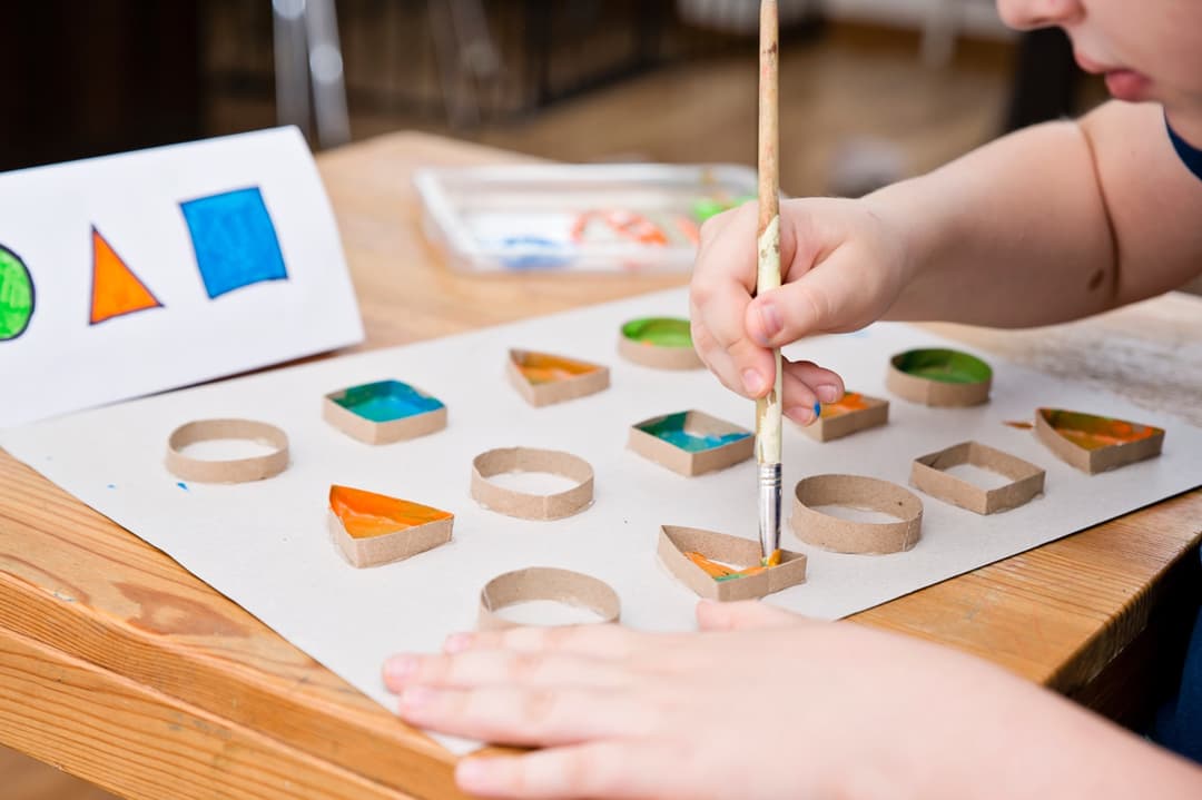 A child painting shapes